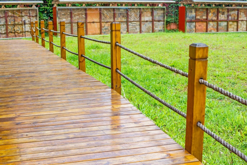 What does a professional flooring contractor consider for timber versus composite decking?