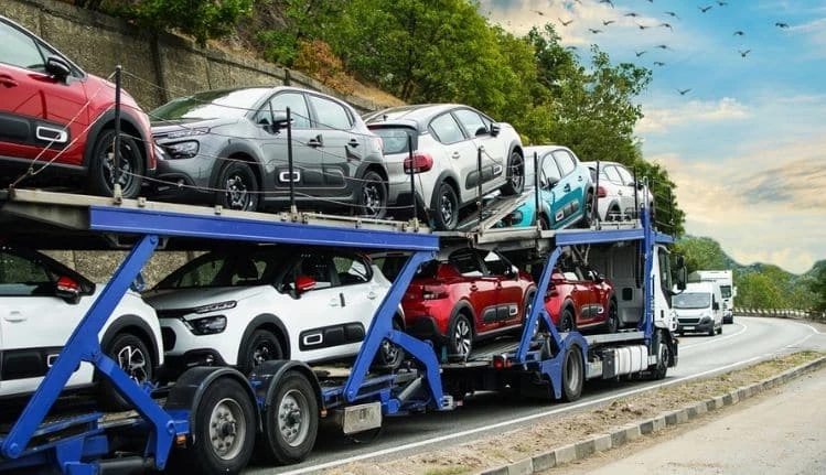 What are the benefits of hiring car transport services in Bangalore?