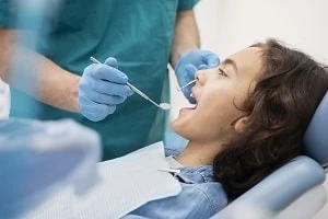 How does a pediatric dentist approach the treatment of cavities in children?
